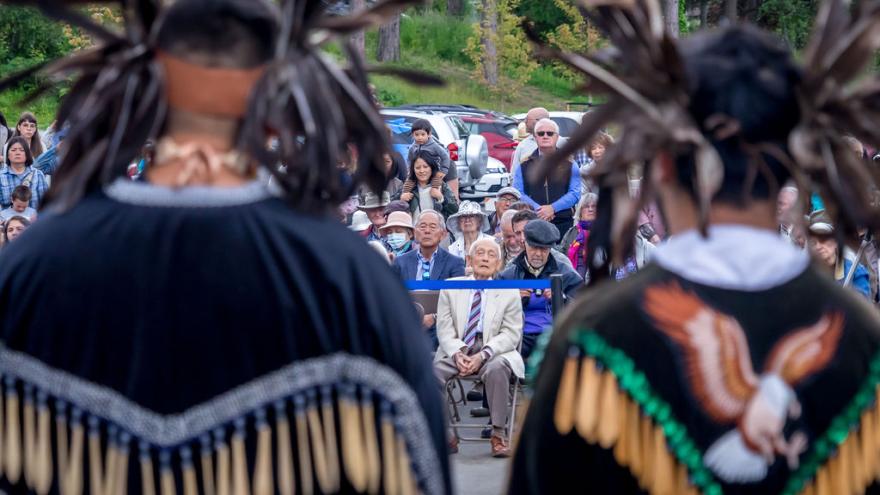 indigenous-dancers-backs-crowd-spectators